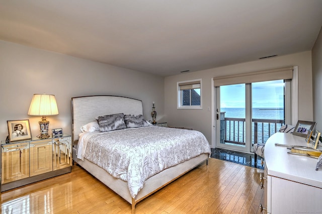 2 Old Town Hwy Unit 45, East Haven, CT 06512 - bedroom featuring access to exterior, light wood-style floors, and a water view
