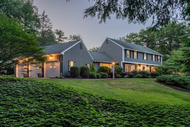 341 W Mountain Rd, Simsbury, CT 06092 - colonial home with board and batten siding, a yard, a garage, and a chimney
