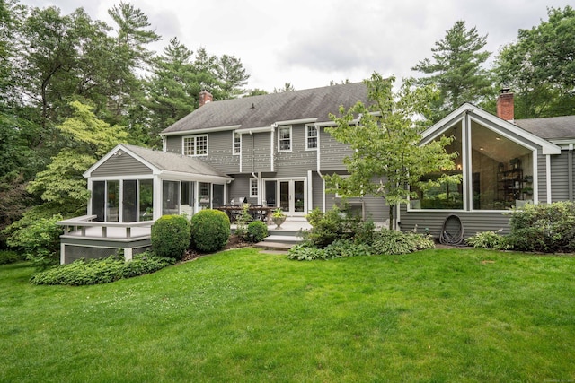 341 W Mountain Rd, Simsbury, CT 06092 - back of property featuring a sunroom, a chimney, and a yard