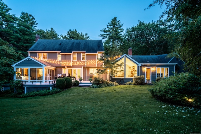 341 W Mountain Rd, Simsbury, CT 06092 - back of property with a chimney, a yard, a sunroom, and a deck