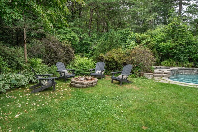 341 W Mountain Rd, Simsbury, CT 06092 - view of grassy yard featuring an outdoor fire pit, an outdoor pool, and a view of trees