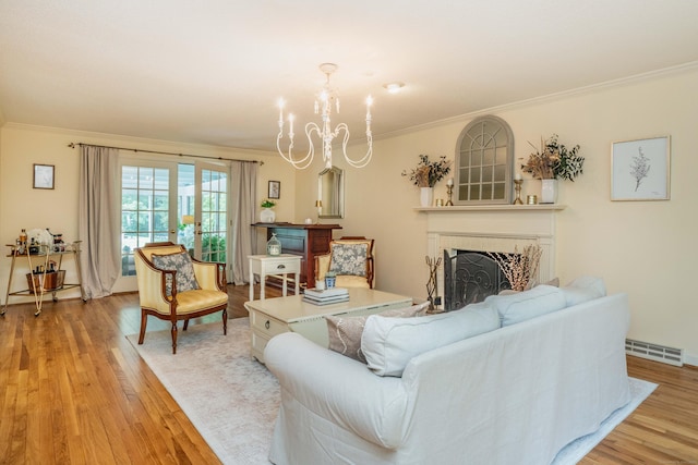 341 W Mountain Rd, Simsbury, CT 06092 - living area featuring ornamental molding, a chandelier, light wood-style flooring, and a fireplace