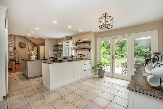 341 W Mountain Rd, Simsbury, CT 06092 - kitchen with dark countertops, open shelves, light tile patterned flooring, recessed lighting, and a chandelier