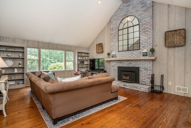 341 W Mountain Rd, Simsbury, CT 06092 - living area with hardwood / wood-style floors, wooden walls, high vaulted ceiling, and built in shelves
