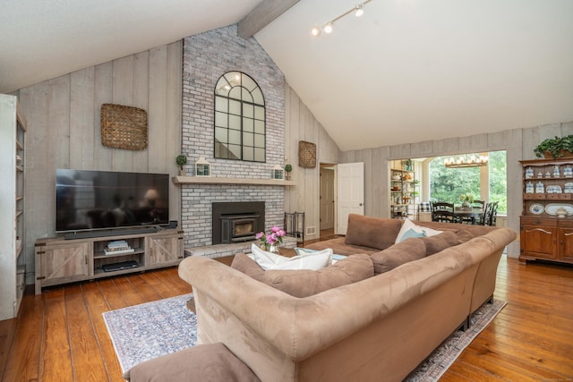 341 W Mountain Rd, Simsbury, CT 06092 - living area featuring wood walls, high vaulted ceiling, hardwood / wood-style floors, beam ceiling, and a brick fireplace