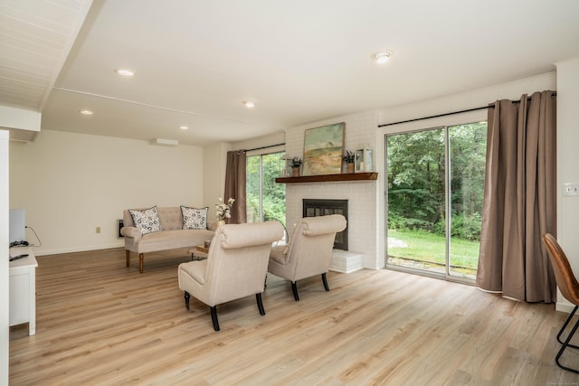 341 W Mountain Rd, Simsbury, CT 06092 - living area with wood finished floors, a brick fireplace, and recessed lighting