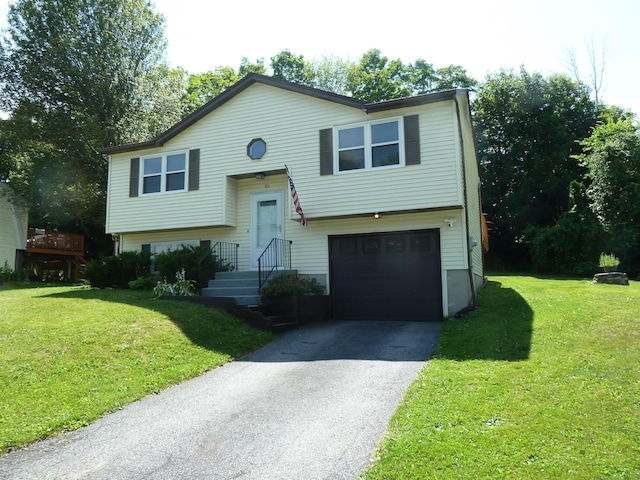 83 Nutmeg Dr, Torrington, CT 06790 - bi-level home featuring an attached garage, driveway, and a front lawn