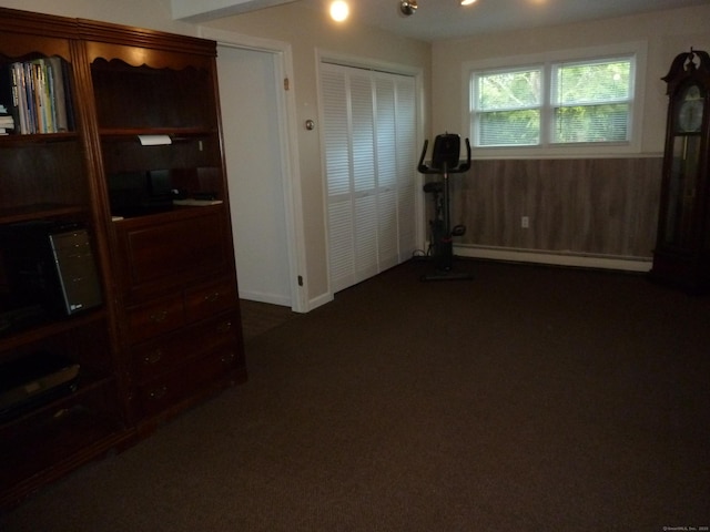 83 Nutmeg Dr, Torrington, CT 06790 - workout area with a baseboard heating unit and dark colored carpet