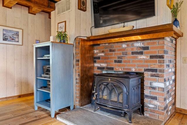 40 Devonshire Dr, Waterford, CT 06385 - detailed view of a wood stove, wooden walls, and wood finished floors