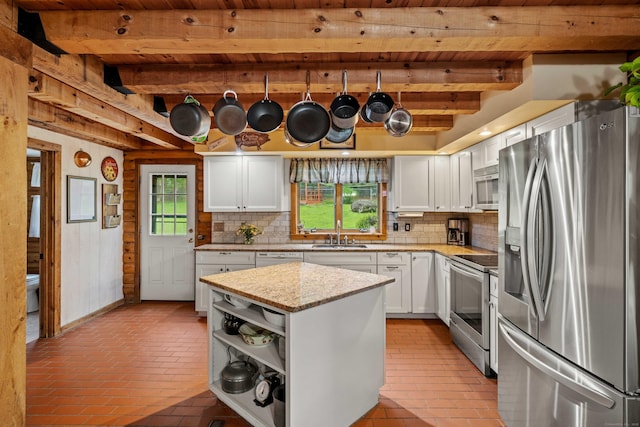 40 Devonshire Dr, Waterford, CT 06385 - kitchen with stainless steel appliances, a wooden ceiling with exposed beams, decorative backsplash, brick floors, and white cabinetry