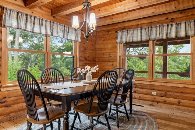40 Devonshire Dr, Waterford, CT 06385 - dining room with a chandelier, healthy amount of natural light, hardwood / wood-style flooring, a wooden ceiling with exposed beams, and wood walls