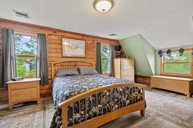40 Devonshire Dr, Waterford, CT 06385 - bedroom with rustic walls, multiple windows, and wood finished floors
