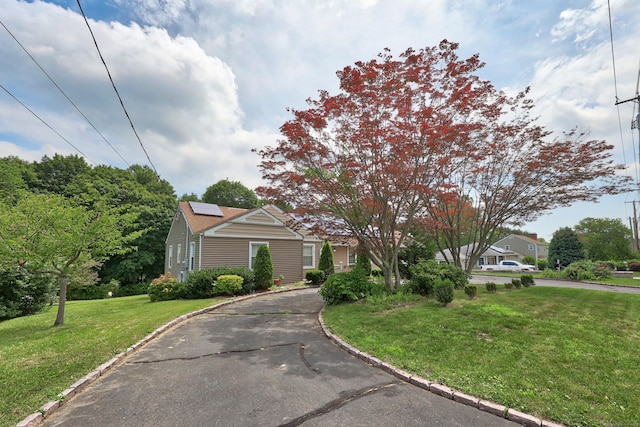 5338 Main St, Trumbull, CT 06611 - view of front facade with roof mounted solar panels and a front yard