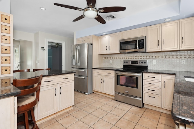 5338 Main St, Trumbull, CT 06611 - kitchen with appliances with stainless steel finishes, a ceiling fan, a kitchen breakfast bar, tasteful backsplash, and recessed lighting