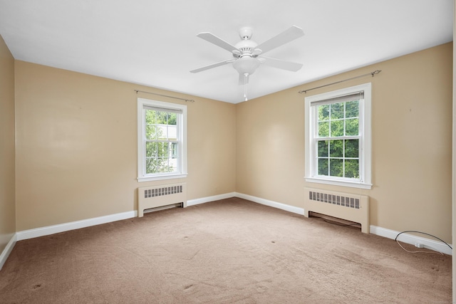 5338 Main St, Trumbull, CT 06611 - carpeted empty room featuring radiator heating unit, plenty of natural light, and ceiling fan
