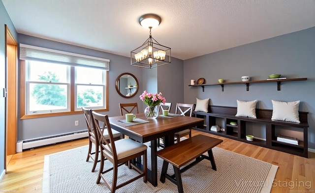 53 Princeton Dr, Middletown, CT 06457 - dining room featuring a baseboard heating unit, a chandelier, and light wood-style flooring