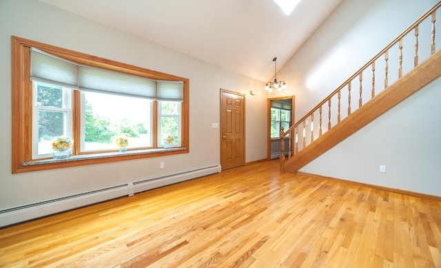 53 Princeton Dr, Middletown, CT 06457 - entryway featuring a baseboard heating unit, a chandelier, wood finished floors, stairway, and vaulted ceiling
