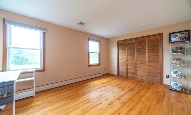 53 Princeton Dr, Middletown, CT 06457 - unfurnished bedroom with light wood-type flooring, a baseboard radiator, and a closet