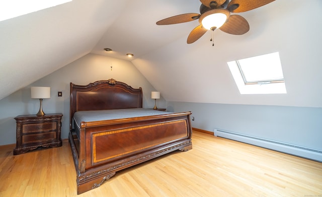 53 Princeton Dr, Middletown, CT 06457 - bedroom featuring a skylight, wood finished floors, lofted ceiling, a baseboard radiator, and a ceiling fan