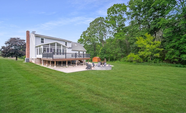 53 Princeton Dr, Middletown, CT 06457 - rear view of house featuring an outdoor fire pit, a sunroom, a patio area, a chimney, and a deck