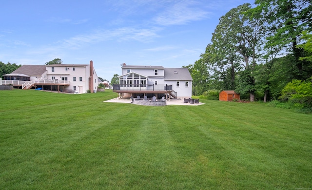 53 Princeton Dr, Middletown, CT 06457 - rear view of property featuring a wooden deck, a shed, a sunroom, a patio, and a yard