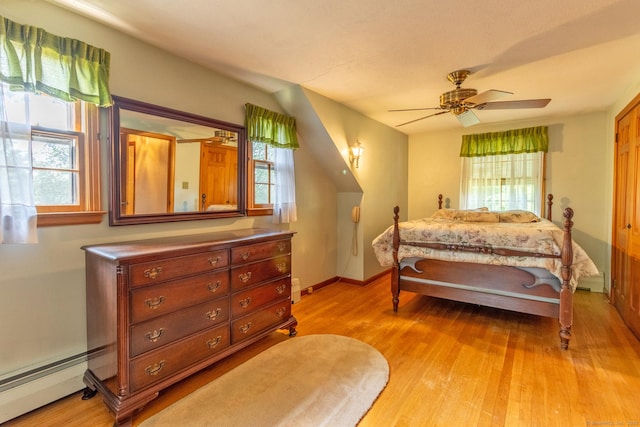 841 S Curtis St, Meriden, CT 06450 - bedroom with a baseboard heating unit, light wood-style floors, and ceiling fan