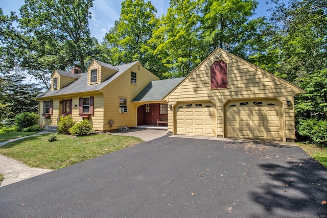 841 S Curtis St, Meriden, CT 06450 - view of front facade with a garage, a front lawn, a chimney, and asphalt driveway