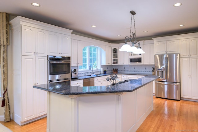 20 Portage Xing, Farmington, CT 06032 - kitchen featuring appliances with stainless steel finishes, white cabinetry, a center island, light wood-style floors, and recessed lighting