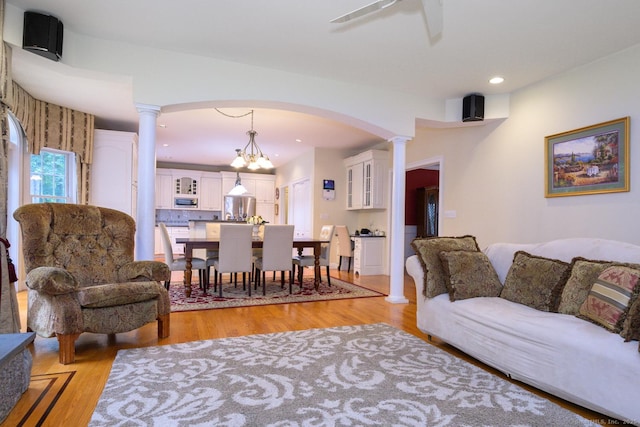 20 Portage Xing, Farmington, CT 06032 - living room featuring light wood finished floors, decorative columns, arched walkways, and recessed lighting