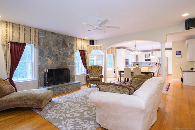 20 Portage Xing, Farmington, CT 06032 - living room featuring light wood-style floors, a ceiling fan, arched walkways, a stone fireplace, and recessed lighting