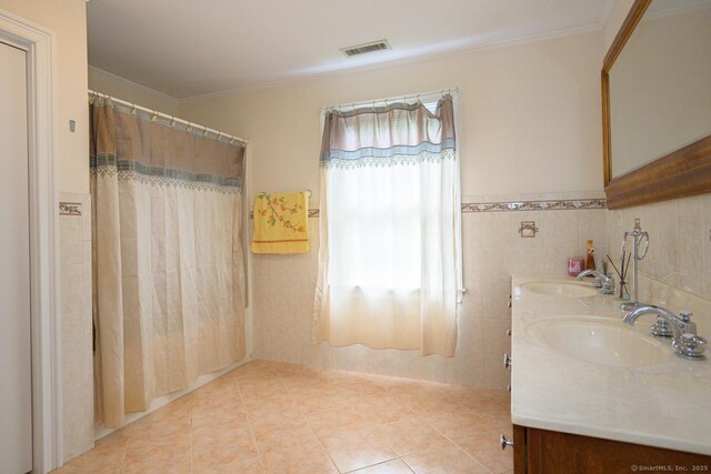 20 Portage Xing, Farmington, CT 06032 - full bath with double vanity, ornamental molding, tile patterned floors, tile walls, and a shower with shower curtain