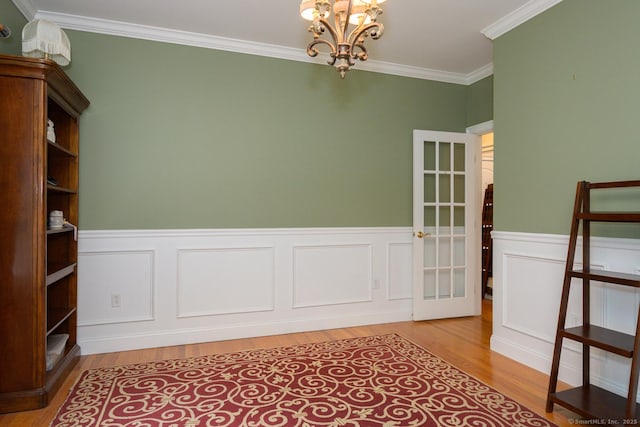 20 Portage Xing, Farmington, CT 06032 - unfurnished room with a chandelier, light wood-type flooring, crown molding, and wainscoting