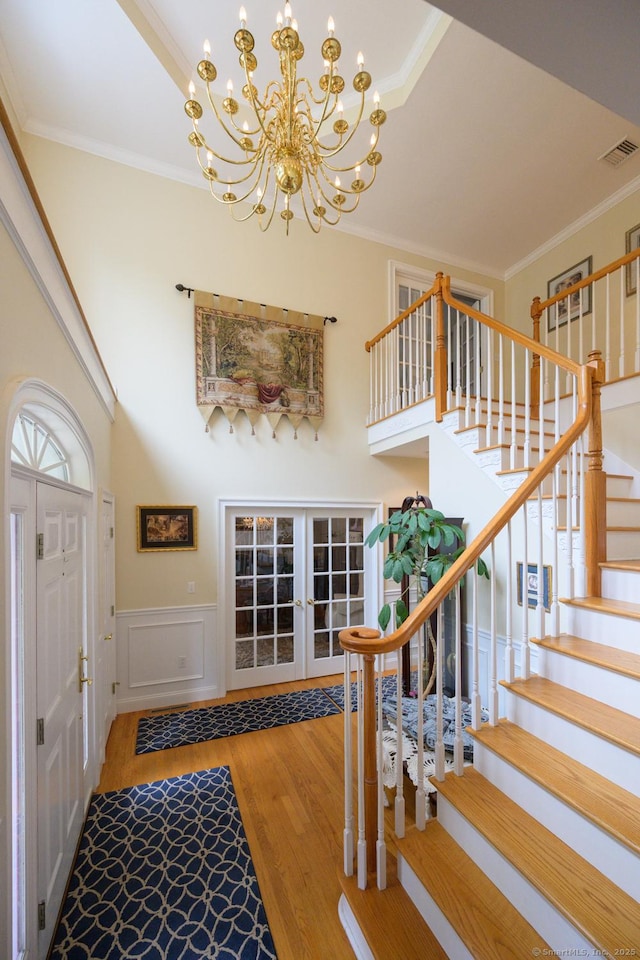 20 Portage Xing, Farmington, CT 06032 - foyer with wood finished floors, a chandelier, ornamental molding, stairs, and french doors