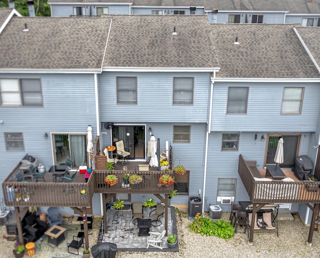 708 Lake Vista Dr Unit 708, East Hampton, CT 06424 - back of house with a patio area, a deck, outdoor dining space, and roof with shingles
