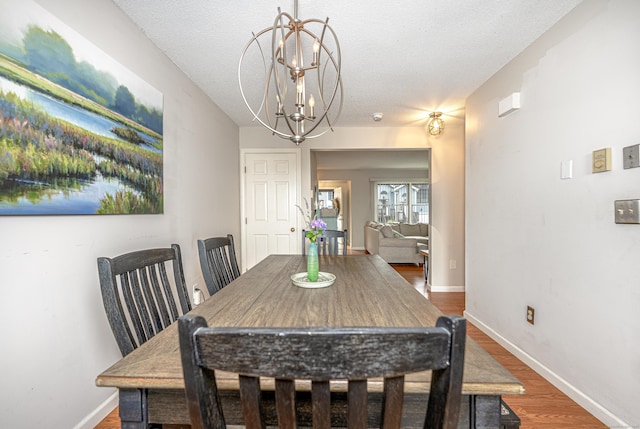 708 Lake Vista Dr Unit 708, East Hampton, CT 06424 - dining area with a chandelier, wood finished floors, and a textured ceiling