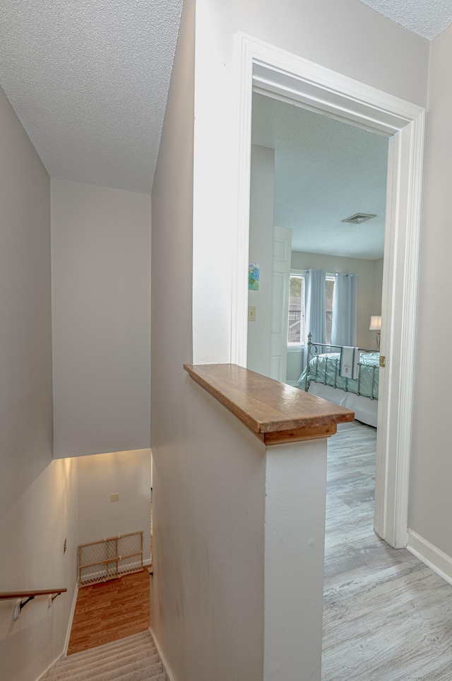 708 Lake Vista Dr Unit 708, East Hampton, CT 06424 - staircase with wood finished floors and a textured ceiling