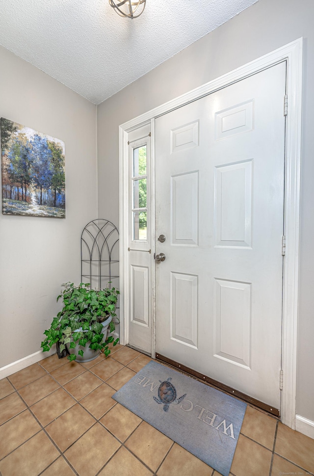 708 Lake Vista Dr Unit 708, East Hampton, CT 06424 - entryway with light tile patterned floors and a textured ceiling