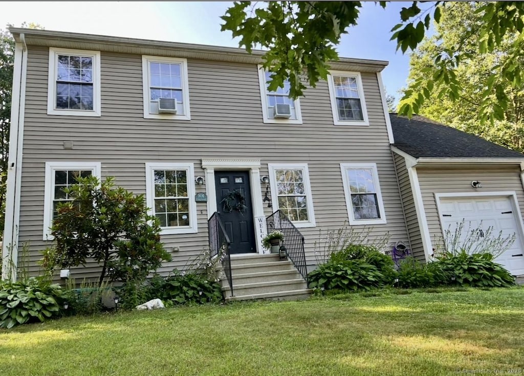 101 Prospect St, Putnam, CT 06260 - view of front of house with a front yard, a garage, entry steps, and cooling unit