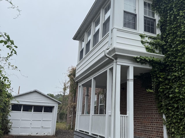 27 Longview Ave, Fairfield, CT 06824 - view of property exterior featuring an outdoor structure, a garage, and covered porch