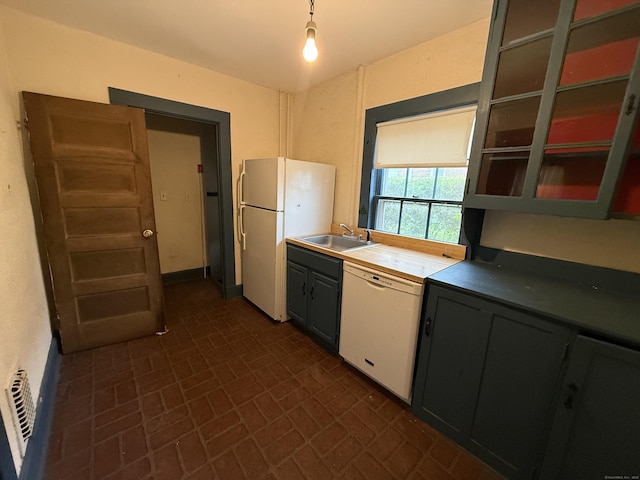 27 Longview Ave, Fairfield, CT 06824 - kitchen featuring white appliances, brick patterned floors, glass insert cabinets, and decorative light fixtures