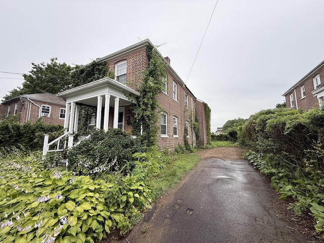 27 Longview Ave, Fairfield, CT 06824 - view of property exterior with brick siding and a chimney