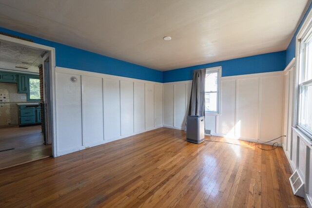102 Vista Dr, East Haven, CT 06512 - unfurnished bedroom featuring a decorative wall and hardwood / wood-style floors