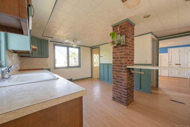 102 Vista Dr, East Haven, CT 06512 - kitchen with green cabinetry, light countertops, light wood-style floors, and a ceiling fan