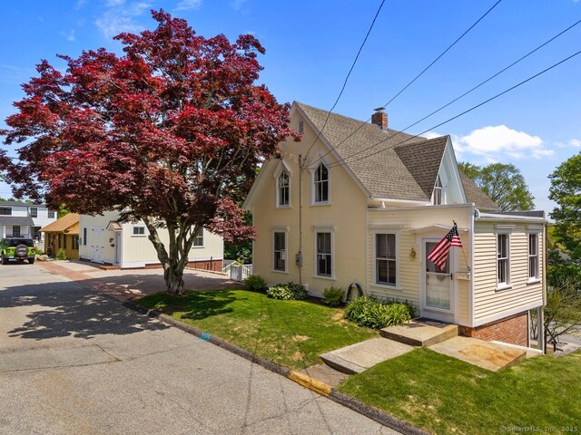 2 Ashby St, Groton, CT 06355 - view of front of house featuring roof with shingles, a chimney, and a front yard