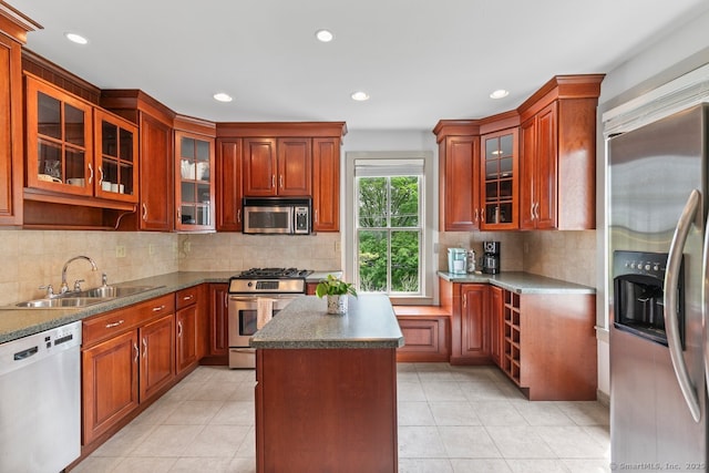 2 Ashby St, Groton, CT 06355 - kitchen with stainless steel appliances, a center island, glass insert cabinets, recessed lighting, and tasteful backsplash