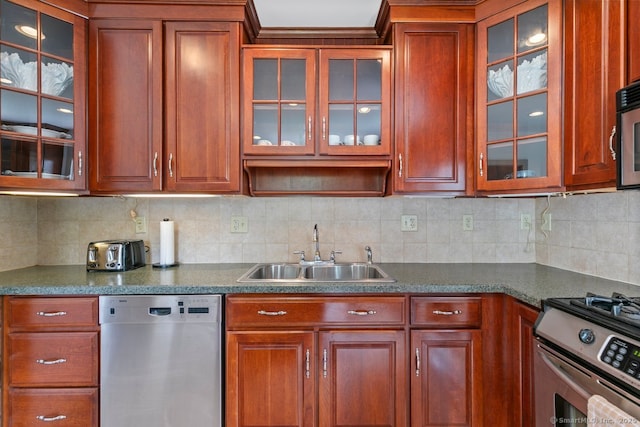 2 Ashby St, Groton, CT 06355 - kitchen featuring appliances with stainless steel finishes, glass insert cabinets, decorative backsplash, and dark countertops