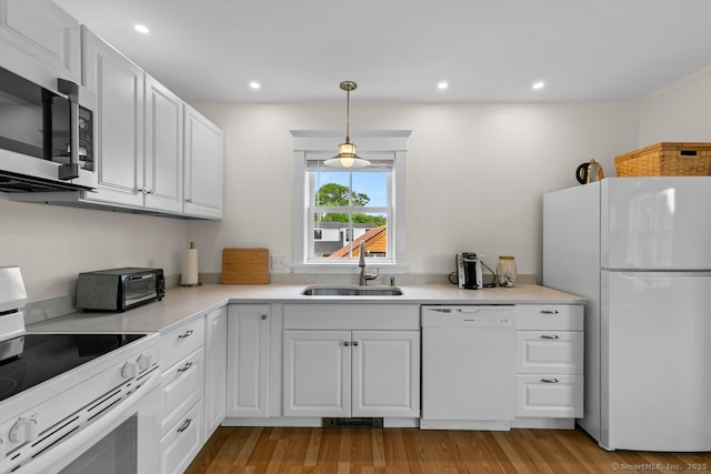 2 Ashby St, Groton, CT 06355 - kitchen with white appliances, light wood-style flooring, white cabinetry, light countertops, and recessed lighting