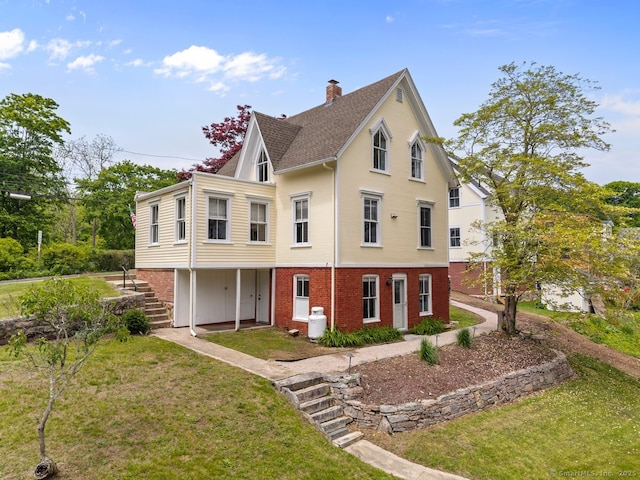 2 Ashby St, Groton, CT 06355 - view of front of property with brick siding, a front yard, a chimney, stairway, and roof with shingles