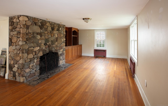 53 Haviland St, Bristol, CT 06010 - unfurnished living room featuring light wood-style floors and a stone fireplace