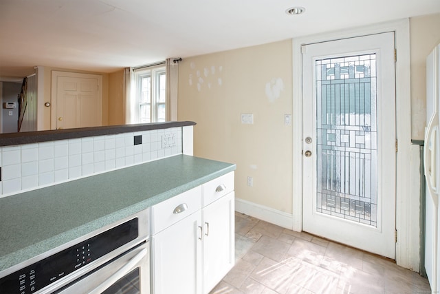 53 Haviland St, Bristol, CT 06010 - kitchen with white cabinets, oven, and recessed lighting